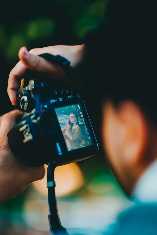 Choose your photographer Photo of photographer with his viewfinder as subject with a woman in view